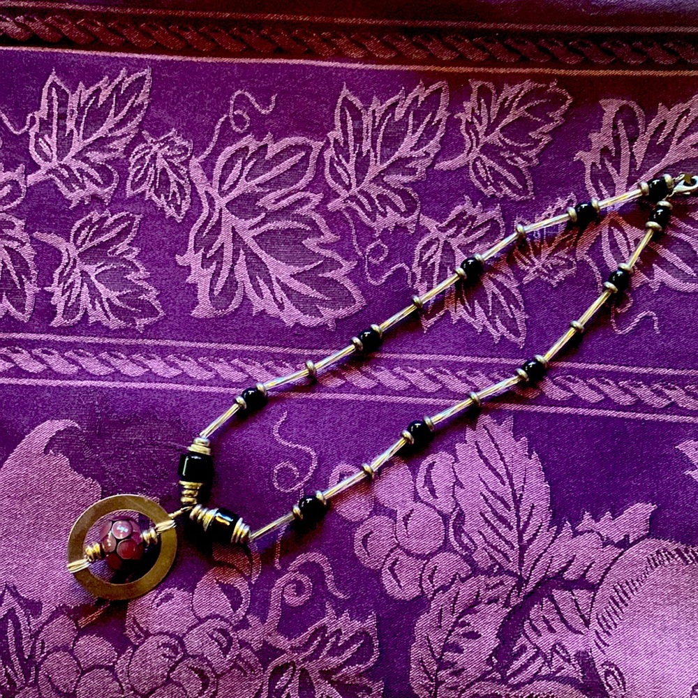 Silver like necklace with purple bead
